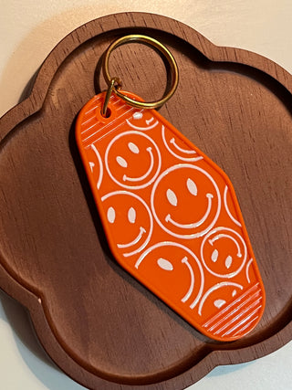 Orange smiley face Motel Keychain